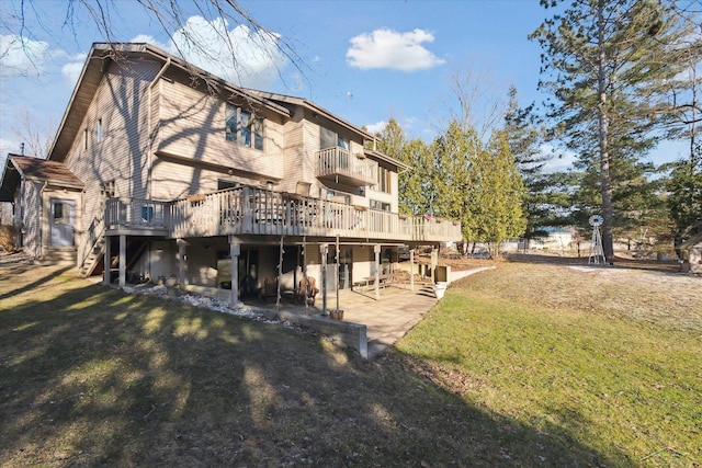 back of house featuring a patio area, a yard, a balcony, and a deck