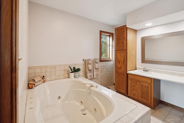 bathroom with vanity, tile patterned flooring, and a relaxing tiled tub