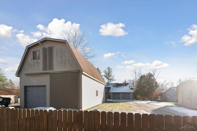 856 Pawtucket Dr, Hope, MI 48628 - exterior space with an outbuilding, a gambrel roof, and a fenced front yard