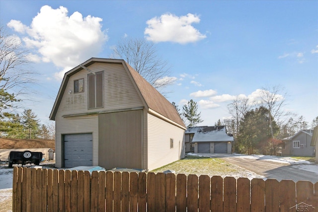 view of property exterior featuring an outdoor structure and a garage