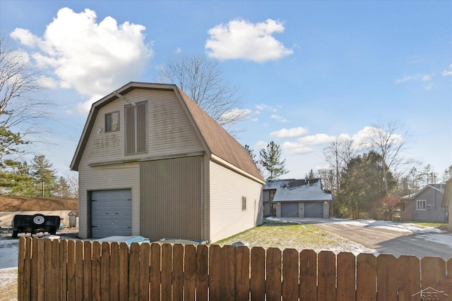 856 Pawtucket Dr, Hope, MI 48628 - view of side of home featuring a gambrel roof, a garage, fence, and an outdoor structure