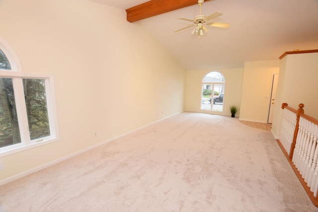 carpeted empty room with vaulted ceiling with beams and ceiling fan