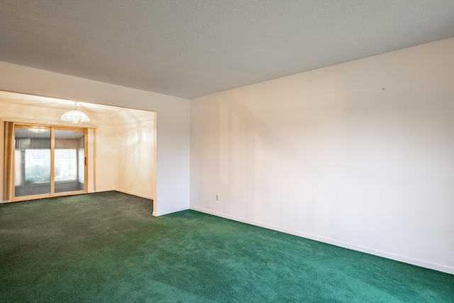 empty room with dark colored carpet