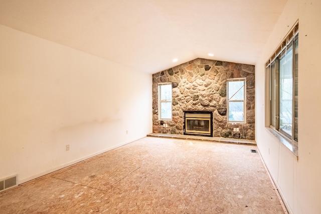 unfurnished living room featuring a fireplace and lofted ceiling