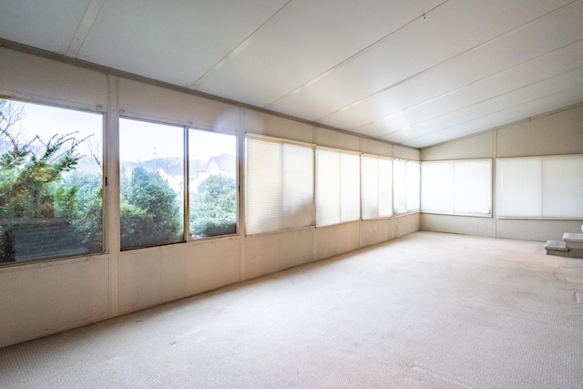 unfurnished sunroom featuring lofted ceiling