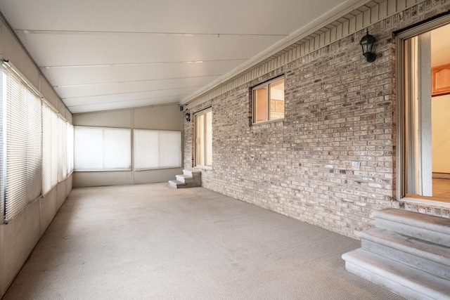 unfurnished sunroom with a wealth of natural light and vaulted ceiling