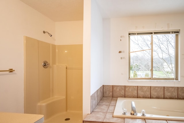 bathroom featuring tile patterned flooring and independent shower and bath