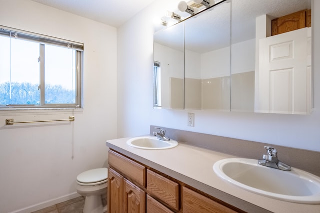 bathroom featuring tile patterned floors, vanity, and toilet