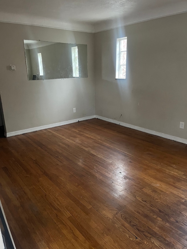 unfurnished room featuring dark hardwood / wood-style flooring