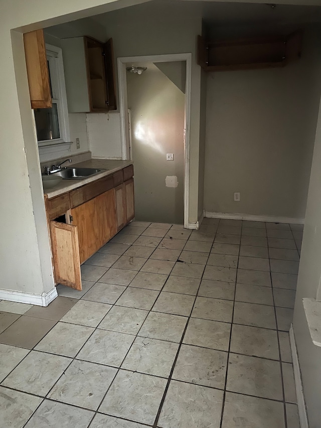 kitchen featuring sink and light tile patterned floors