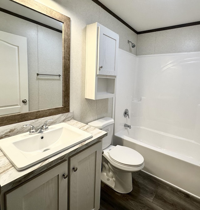 full bathroom with hardwood / wood-style floors, vanity, shower / tub combination, crown molding, and toilet