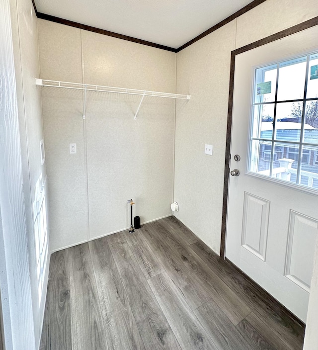 laundry area with hardwood / wood-style floors and crown molding