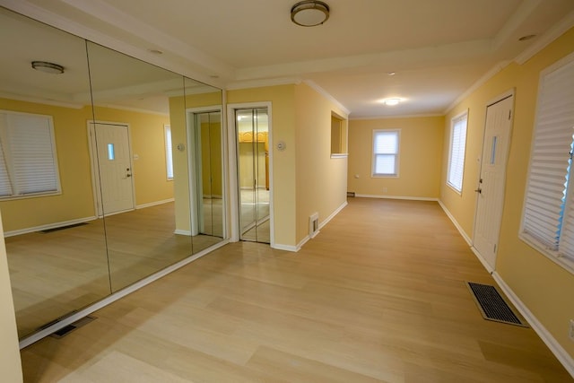 hallway featuring wood-type flooring and crown molding