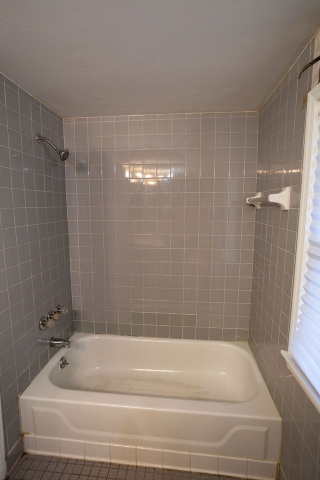 bathroom with tile patterned floors and tiled shower / bath combo