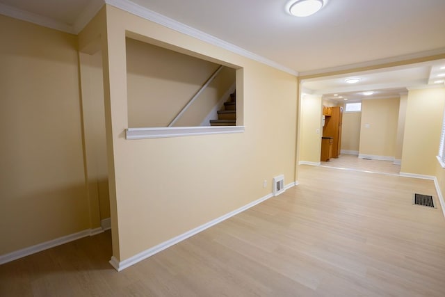 corridor featuring crown molding and light hardwood / wood-style flooring