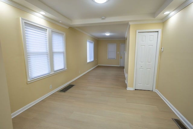 corridor featuring light wood-type flooring and crown molding