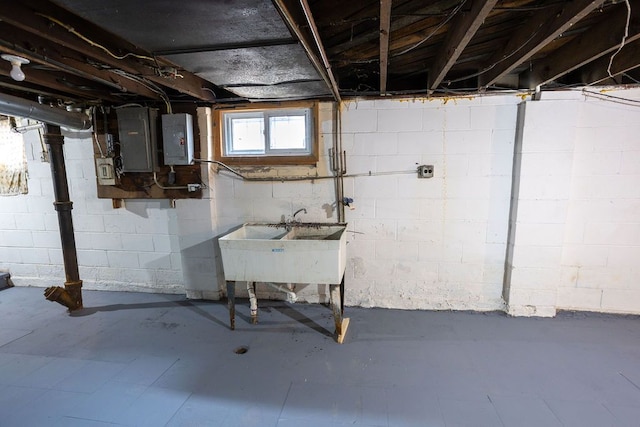 basement featuring electric panel and sink