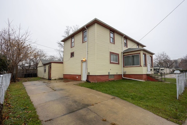 view of side of home featuring a lawn