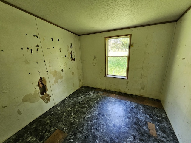 spare room with a textured ceiling