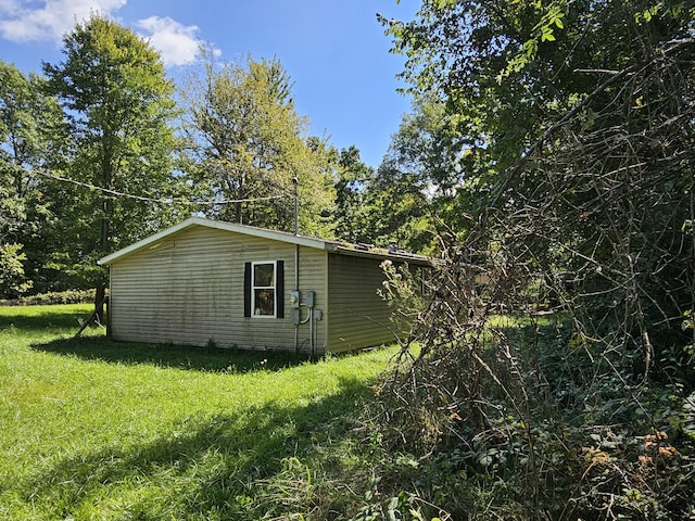 view of side of home with a yard