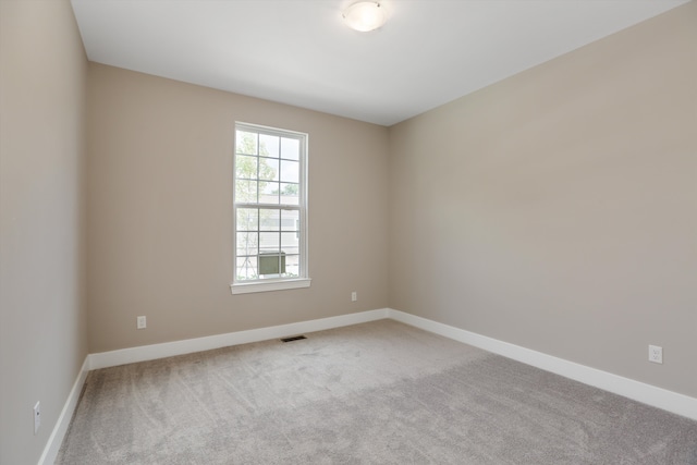 spare room featuring light carpet