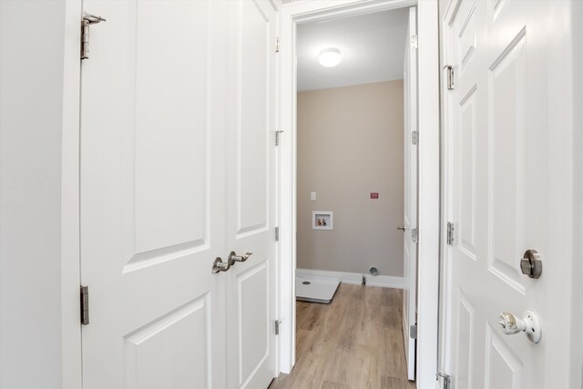 clothes washing area featuring hookup for a washing machine and light hardwood / wood-style floors