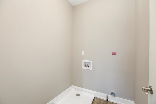 clothes washing area featuring gas dryer hookup, hookup for a washing machine, and wood-type flooring