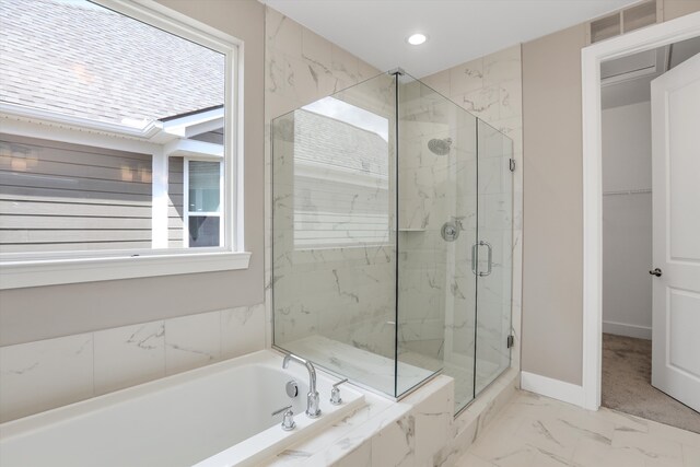 bathroom featuring independent shower and bath