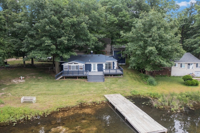 exterior space featuring a deck with water view and a yard