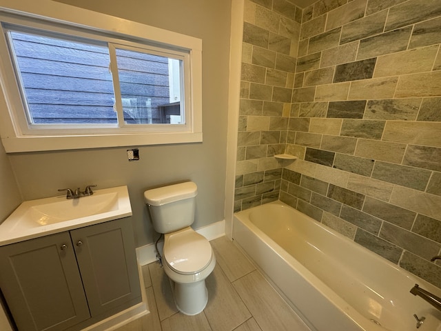 full bathroom featuring vanity, toilet, and tiled shower / bath