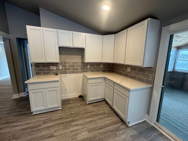 kitchen with white cabinets, decorative backsplash, and dark hardwood / wood-style flooring