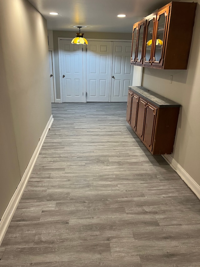 hallway with light hardwood / wood-style flooring