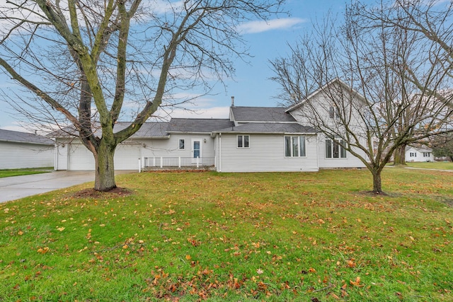 7493 S Saginaw St, New Lothrop, MI 48460 - view of home's exterior with driveway, an attached garage, and a lawn