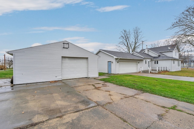 7493 S Saginaw St, New Lothrop, MI 48460 - view of front of property featuring a front lawn, a detached garage, and driveway