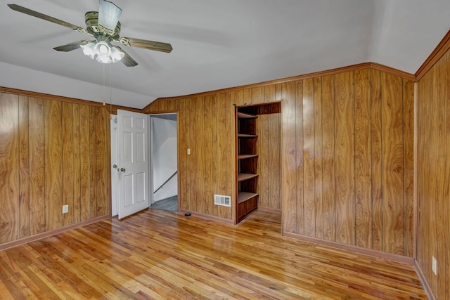 7493 S Saginaw St, New Lothrop, MI 48460 - empty room with wood walls, wood finished floors, ceiling fan, and vaulted ceiling