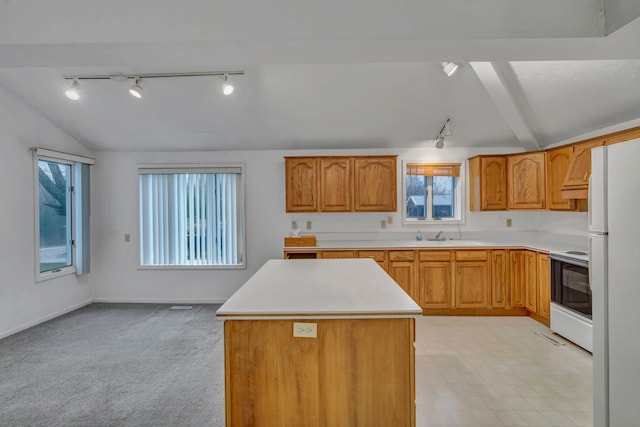 7493 S Saginaw St, New Lothrop, MI 48460 - kitchen with rail lighting, white appliances, vaulted ceiling, light countertops, and a center island