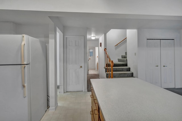 7493 S Saginaw St, New Lothrop, MI 48460 - kitchen with freestanding refrigerator, light countertops, and light floors