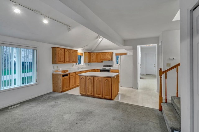 7493 S Saginaw St, New Lothrop, MI 48460 - kitchen featuring track lighting, black range with electric stovetop, freestanding refrigerator, light countertops, and a center island