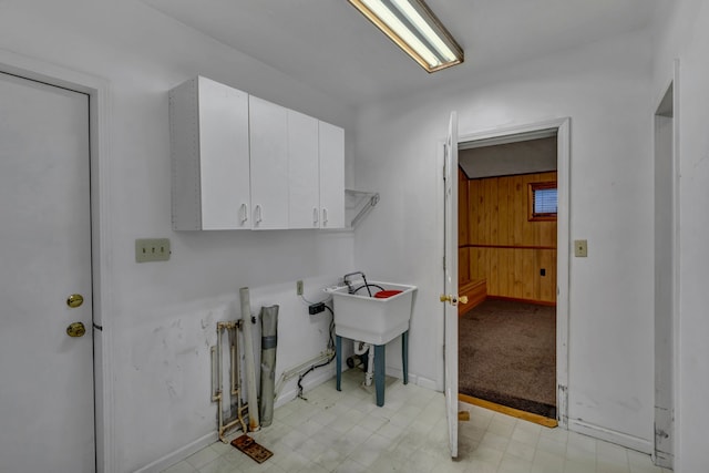 7493 S Saginaw St, New Lothrop, MI 48460 - laundry area featuring wood walls, cabinet space, and light floors