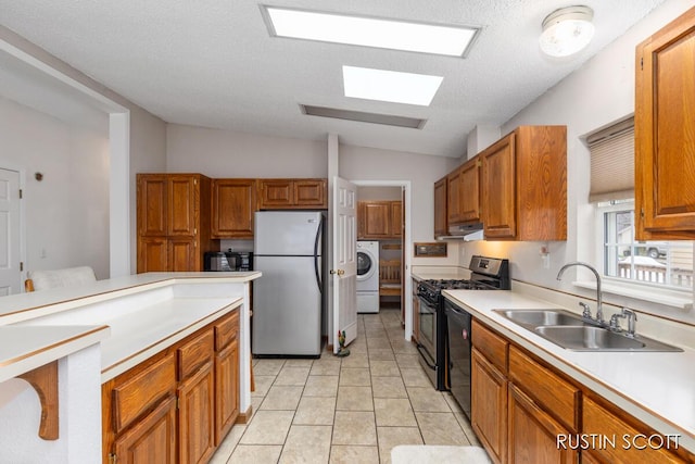 2008 Parker Dr, Wayland, MI 49348 - kitchen featuring gas range oven, a sink, washer / dryer, freestanding refrigerator, and dishwashing machine