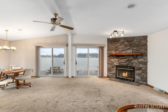 2008 Parker Dr, Wayland, MI 49348 - living area featuring carpet flooring, a wealth of natural light, vaulted ceiling with beams, and ceiling fan with notable chandelier