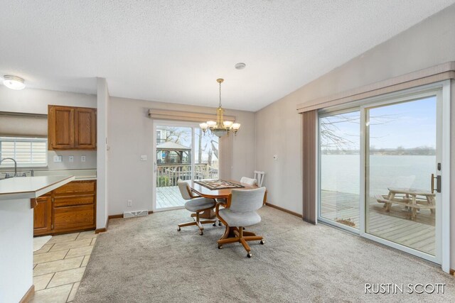 2008 Parker Dr, Wayland, MI 49348 - dining area with vaulted ceiling, visible vents, a chandelier, and a healthy amount of sunlight