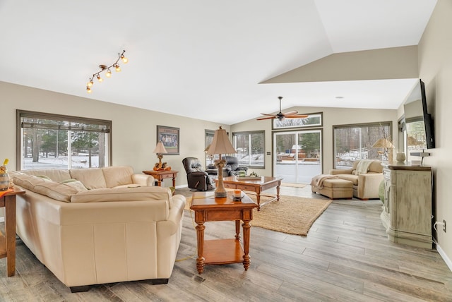 1571 Loebrich Dr, Gladwin, MI 48624 - living area featuring lofted ceiling, a ceiling fan, and light wood-style flooring