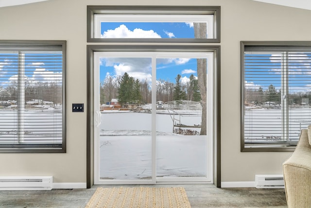 doorway to outside featuring a baseboard radiator, vaulted ceiling, and hardwood / wood-style flooring