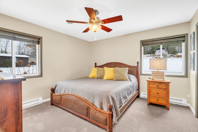 bedroom with baseboard heating, ceiling fan, and dark carpet