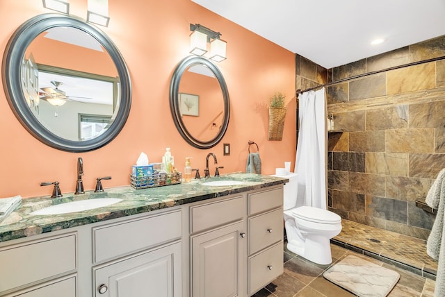 bathroom featuring ceiling fan, tile patterned floors, toilet, vanity, and a shower with shower curtain