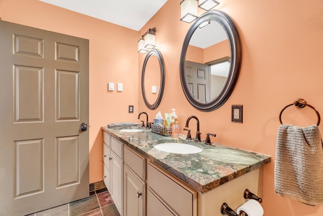 1571 Loebrich Dr, Gladwin, MI 48624 - bathroom featuring double vanity and stone finish floors