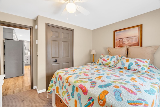 1571 Loebrich Dr, Gladwin, MI 48624 - bedroom featuring freestanding refrigerator, light colored carpet, and ceiling fan