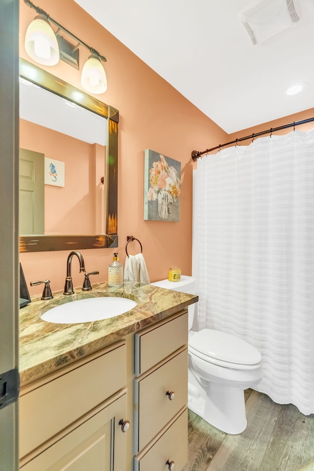 bathroom featuring hardwood / wood-style flooring, vanity, and toilet