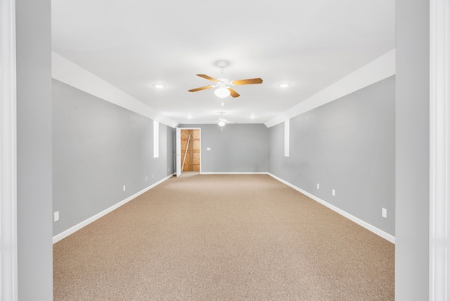 carpeted empty room featuring ceiling fan